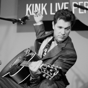 Chris Isaak plays guitar at the KINK Live Performance Lounge