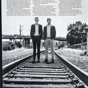 Oliver Alexander and Orion Falvey standing on railroad track for environmental portrait