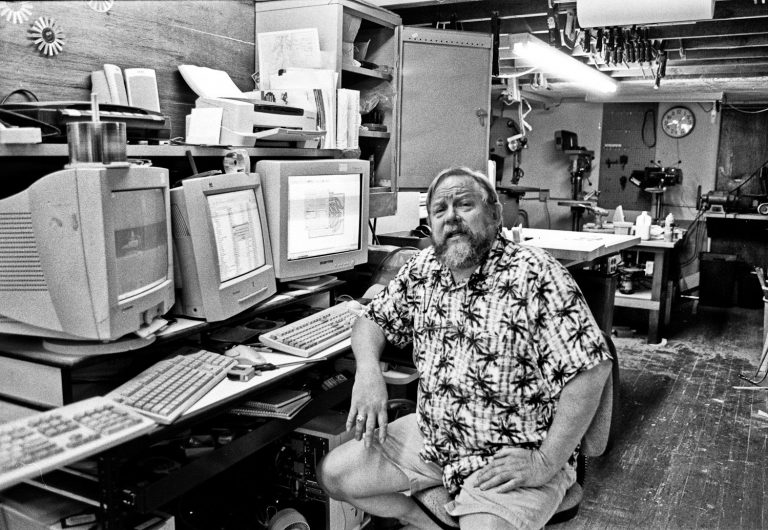 Bridge City Systems - a computer store/wood shop man sitting at desk